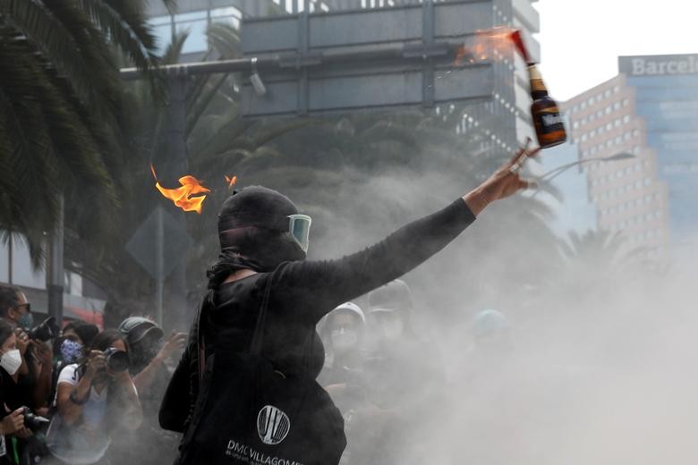 A member of a feminist collective throws a Molotov cocktail during a protest to mark the International Safe Abortion Day in Mexico City, Mexico September 28, 2020. REUTERS/Carlos Jasso